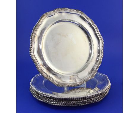 A set of eight early 1970's silver dinner plates by Roberts & Belk, of shaped circular form, with gadrooned border, Sheffield