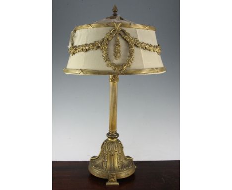 An early 20th century ormolu table lamp, the circular fabric shade with floral swag mounts, 23in.