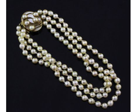 A 1990's triple strand cultured pearl choker necklace with a stylish mother of pearl set 18ct gold clasp, 12in.