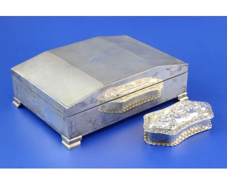 A 1950's Art Deco style engine turned silver cigarette box, of rectangular form, with shaped lid and engraved initials, on br