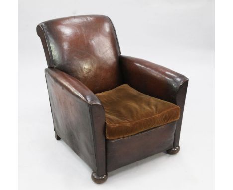 A 1930's brown leather upholstered armchair, with brown velvet upholstered seat cushion