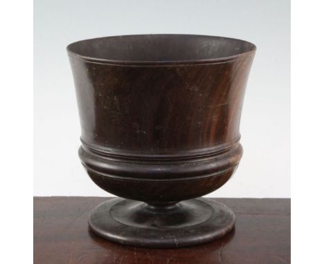 A late 17th century lignum vitae wassail cup, ring turned on circular spreading foot, 7.25in., repaired