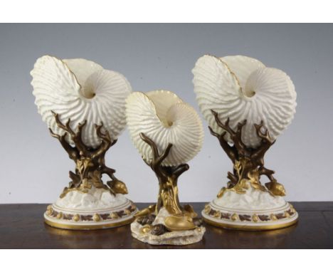 Three Royal Worcester 'nautilus shell' vases, late 19th century, comprising a pair and a smaller example, the nautilus shell 
