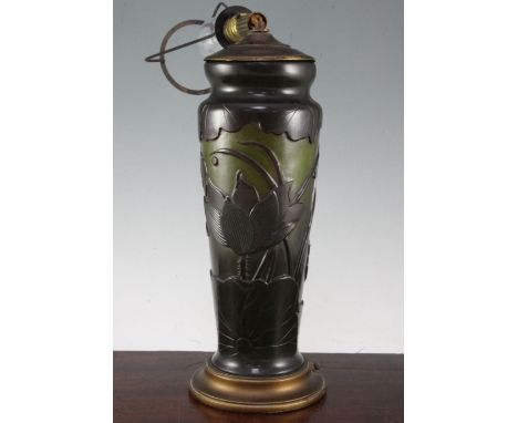 A Galle style lily pattern cameo glass lamp base, 20th century, overlaid in orange on green / yellow glass, bears Galle signa
