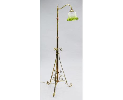 An Edwardian copper and brass adjustable standard lamp, with single scrolling branch, with green tinted crimped glass shade, 