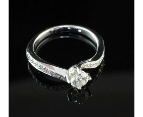 An 18ct white gold single stone diamond ring with diamond set shoulders, in Tolkowsky box, with a total diamond weight of 0.5