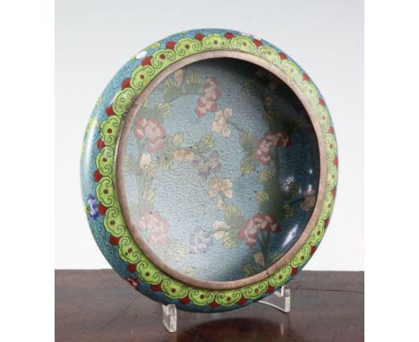 A Chinese cloisonne enamel compressed circular bowl, early 20th century, decorated with flowers and foliage on a pale blue gr