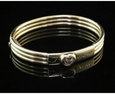 An 18ct gold Chopard "I Love You" hinged bangle, of reeded form, the glazed heart motif set with "floating" diamond, gross we