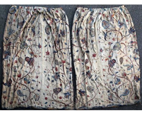 A pair of 1920's silk lined crewel work curtains, depicting birds, flowers and berries, 7ft 10ins long