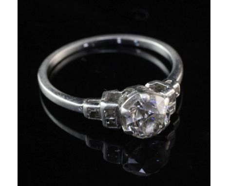 A 1940's/1950's platinum and single stone diamond ring, with square cut diamond set shoulders, the central round cut stone we