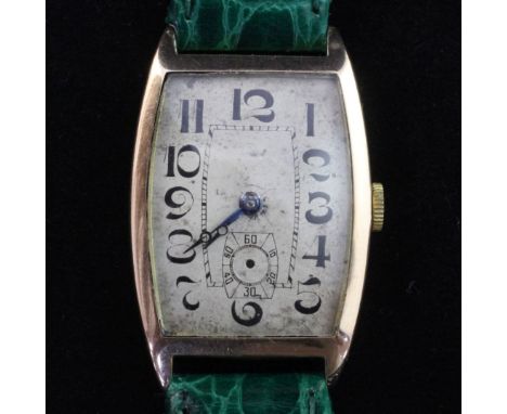 A gentleman's stylish 1920's Swiss 9ct gold manual wind wrist watch, with tonneau shaped Arabic dial and subsidiary seconds (