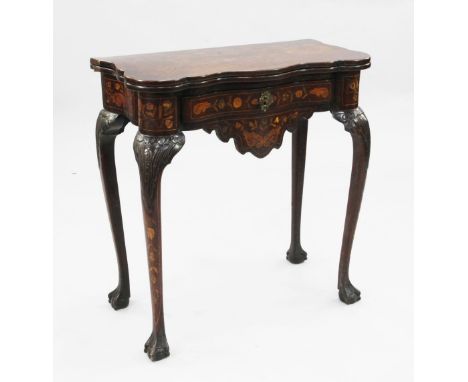 An early 19th century Dutch marquetry inlaid serpentine card table, with fold-over top revealing baize lined interior and cor