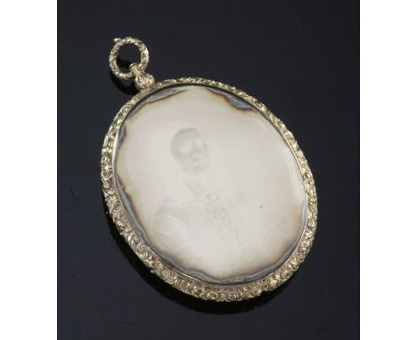 An oval Victorian daguerreotype mourning pendant, with chased gilt metal frame depicting a portrait of a lady, with floral ha