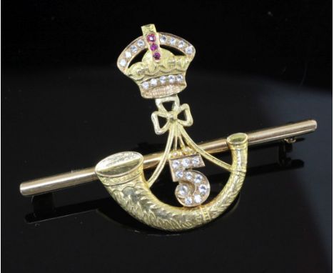 An Indian? high carat gold and gem set military related sweetheart's bar brooch, modelled as a gem set coronet above a white 