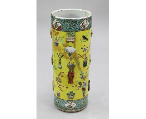 A Chinese yellow glazed and moulded porcelain 'Hundred Antiques' cylindrical stick stand, second half 19th century, painted w