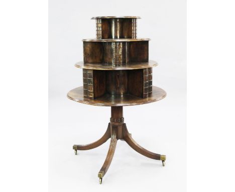 A George III mahogany revolving bookcase, circa 1820, with circular graduated three tier top, with faux binding divisions, on