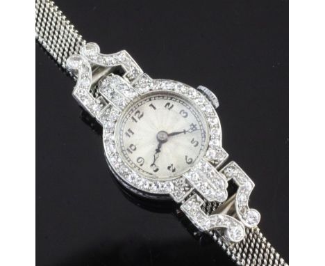 A lady's 1930's/1940's platinum and diamond cocktail watch, with Arabic dial, the bezel and lugs set with eight cut diamonds 