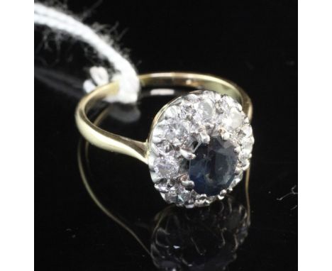 An 18ct gold and platinum, sapphire and diamond cluster ring, of oval form, size O.