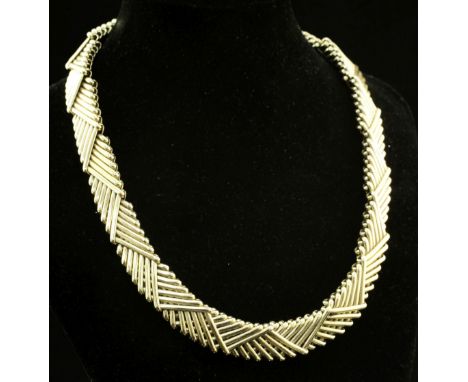A stylish late 1980's Kutchinsky 18ct gold interwoven double link necklace, with triangular motifs, signed and hallmarked for