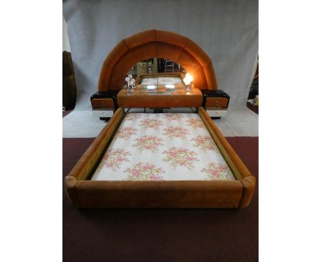 A highly unusual 1970's vintage bedstead with arched velour upholstered and mirrored head board with fitted twin globe lights