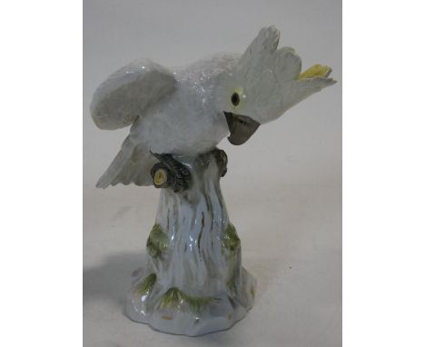 A 19th century Meissen hand painted porcelain cockatoo. With yellow crest and perched on a log.  First modelled by J.J.Kaendl