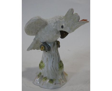 A 19th century Meissen hand painted porcelain cockatoo. With red crest and perched on a log.  First modelled by J.J.Kaendler 