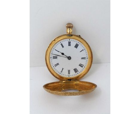 A 19th century ladies pocket watch in 18ct yellow gold, the half hunter case all over engraved with foliate scrolls, pink and