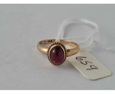A cabochon garnet ring in 9ct size M