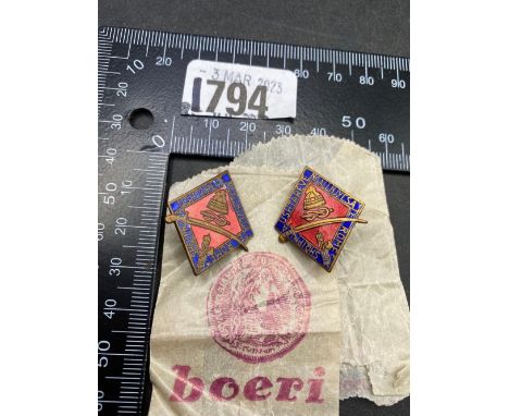 Two Mussolini enamel badges with packets