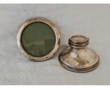 A Capstan shaped ink stand with hinged cover and a circular photo frame