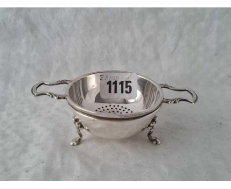 A tea strainer on stand with four pad feet, Birmingham 1959