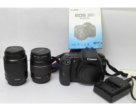 A Canon EOS 20D DSLR, Canon f3.5-5.6 28-80mm zoom,  Canon 80-200mm zoom, battery charger, manual and 1gb CF card 