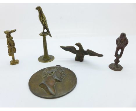 Three pipe tampers, a portrait plaque and an eagle finial 