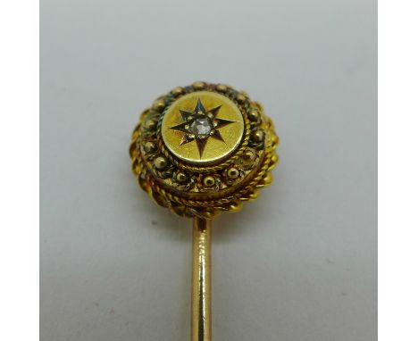 A yellow metal and diamond stick pin, 1.9g 