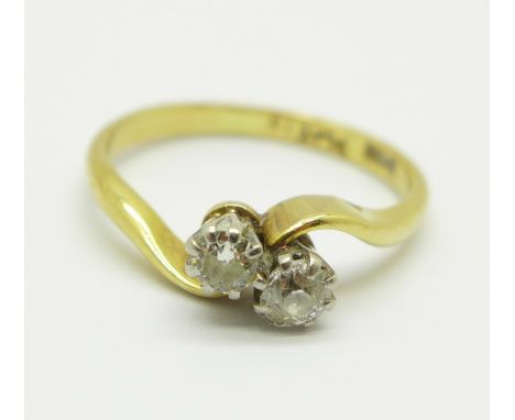 An 18ct gold, two stone diamond twist ring, 2.6g, L 