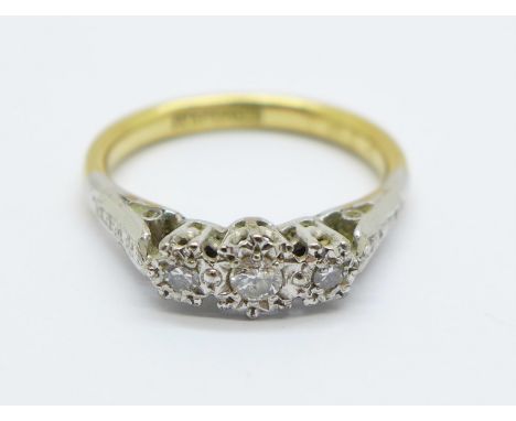 An 18ct gold, three stone diamond ring, 2.9g, K 