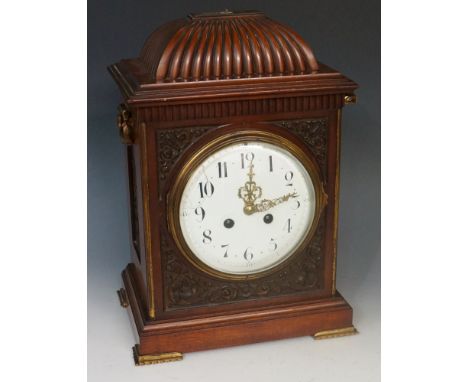 A George II style mahogany bracket clock, the fluted domed top with pineapple finial, the frieze fluted above a front  carved