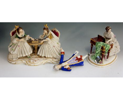 A selection of two porcelain figures, one of two ladies playing chess with a gentleman in blue coat looking on, base marked D