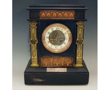A Victorian black slate mantel clock of architectural form, the frieze inlaid with copper panel cast anthemion, scrolls and p