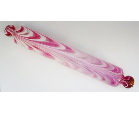 A 19th Century Nailsea pink and white glass rolling pin, 43cm long