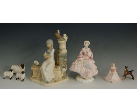 A selection of porcelain and pottery items to include: three Beswick sheep; a Beswick figure of a foal; a small Coalport fema