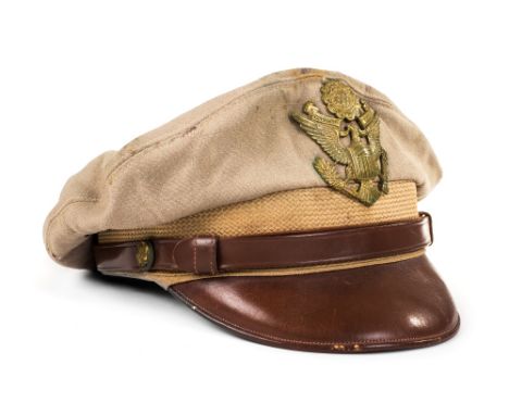 *United States Army. A WWII U.S. Army Officer's hat,  khaki cloth with brown leather peak, brass cap badge and buttons, the l