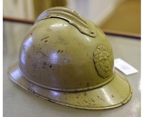 *Helmet. A WWI Belgium Army "Adrian" M-15 helmet,  painted in khaki with lion mask badge to front, original leather lining   