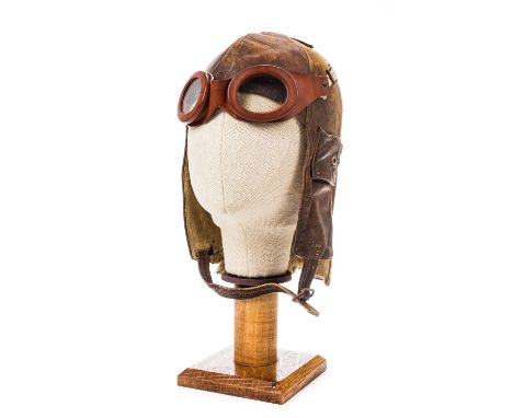 *Flying Helmet. A WWI period leather flying helmet,  brown leather with felt lining, button down ear straps, extending neck p
