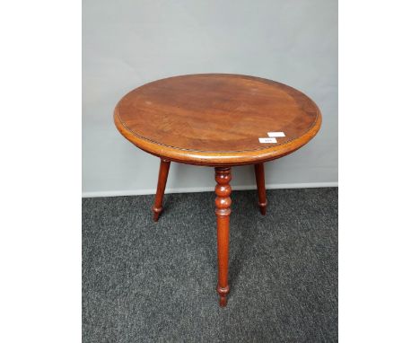 An early 20th century three leg table, Barrel top and supported on bobbin and turned legs. [69high, 61cm diameter] 