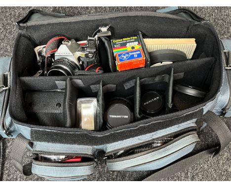 A Camera bag containing a Pentax camera, Bell &amp; Howell lens and various other accessories 