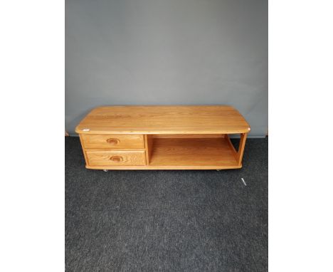 An Ercol Golden Dawn elm wood coffee table. [40x124x53cm] 