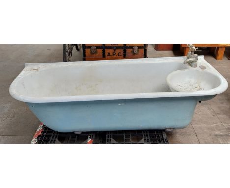 Antique cast metal and enamel bath tub with fitted taps , comes with pedestal legs. 