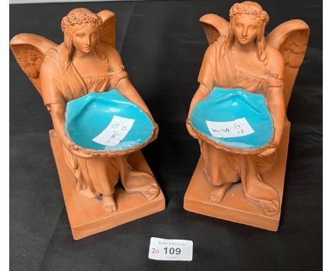 A Pair of 19th century Terracotta angel figures holding shells, Shell is finished with a blue enamel. [20cm high] 