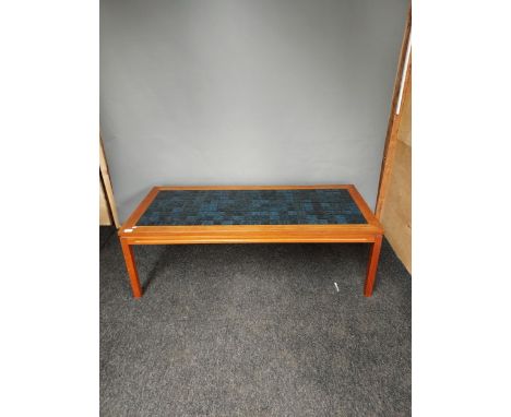 A Mid century teak and blue tile top coffee table. [46x140x61cm] 